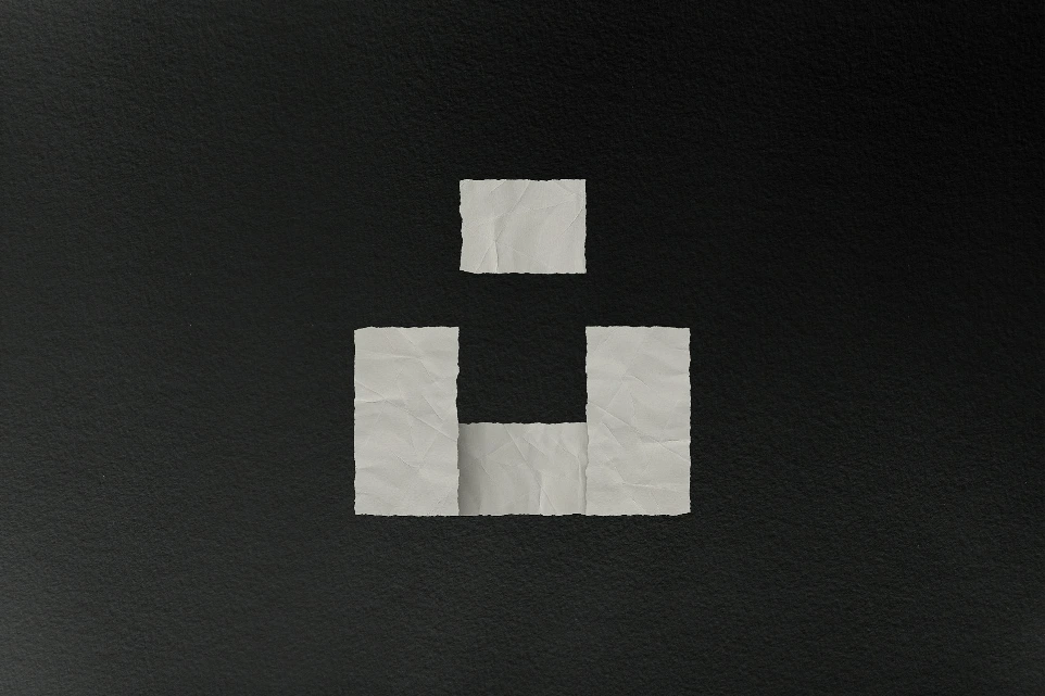 a black and white photo of a piece of paper with the letter h on it